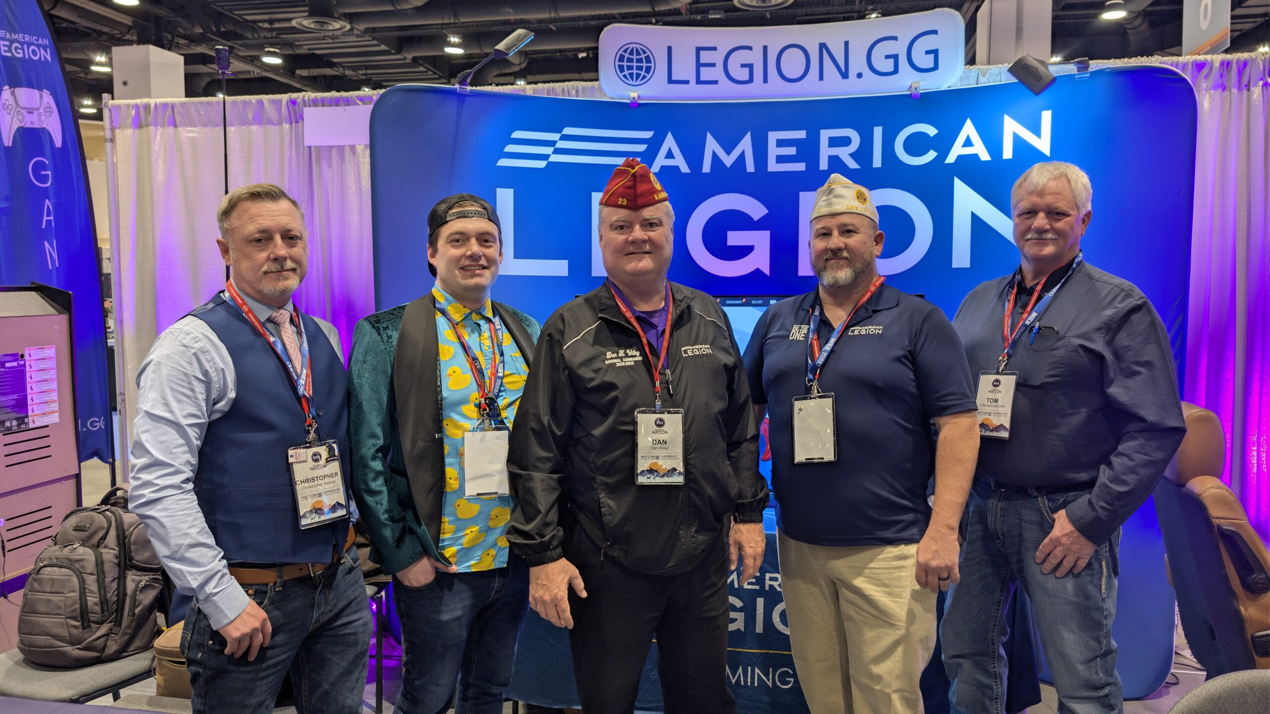 American Legion National Commander Dan K. Wiley (wearing a red cap in the middle) at The American Legion booth at the 2026 Student Veterans of America NatCon.